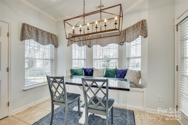 tiled dining room featuring a chandelier, crown molding, and breakfast area