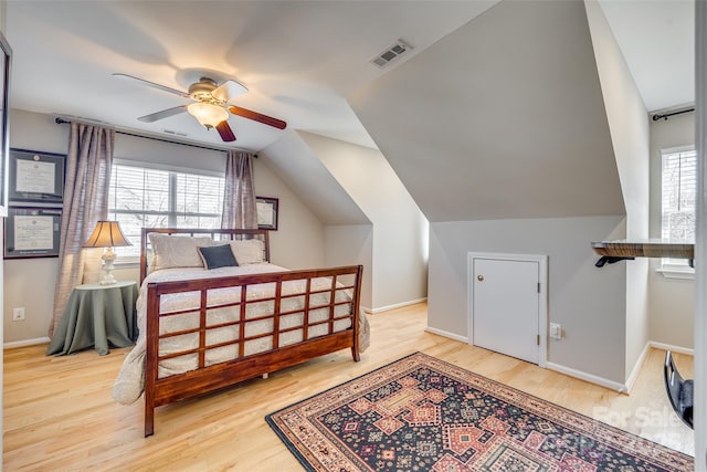 bedroom featuring ceiling fan, wood-type flooring, and lofted ceiling