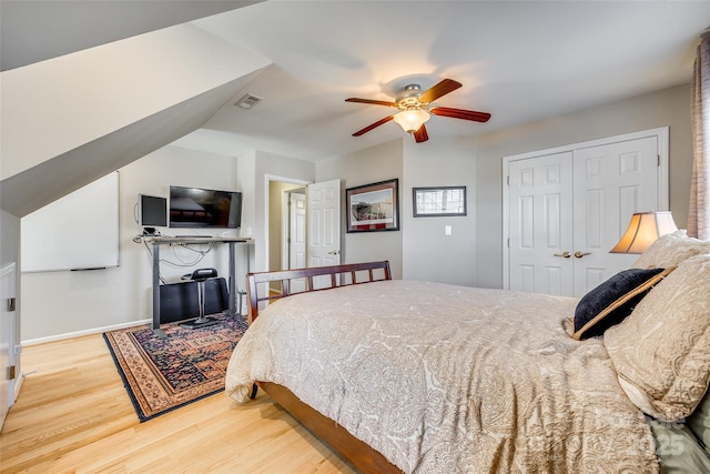 bedroom featuring hardwood / wood-style floors, a closet, and ceiling fan