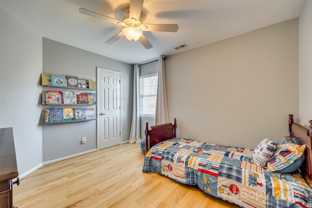 bedroom featuring ceiling fan, a closet, and light hardwood / wood-style floors