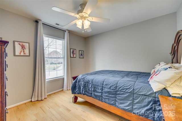 bedroom with light hardwood / wood-style floors and ceiling fan