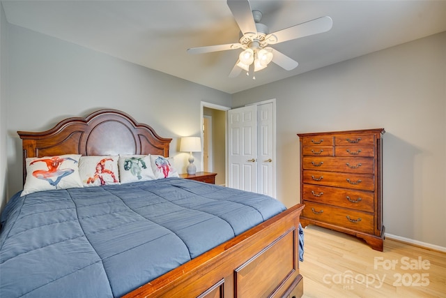 bedroom featuring light wood-type flooring, a closet, and ceiling fan