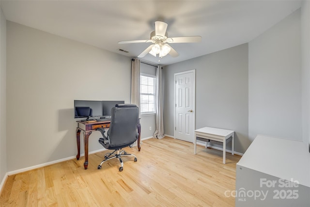 home office featuring ceiling fan and light hardwood / wood-style flooring