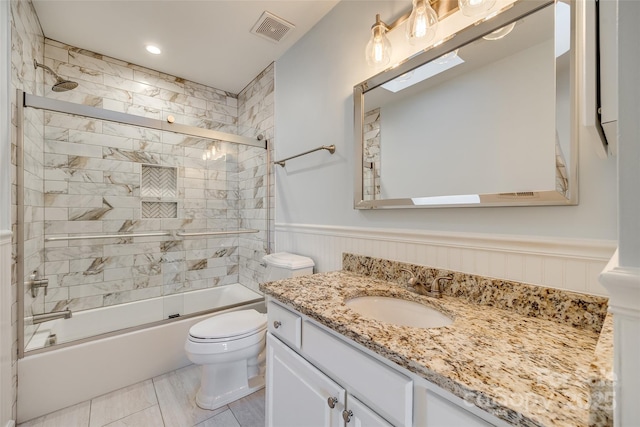 full bathroom with toilet, vanity, and combined bath / shower with glass door