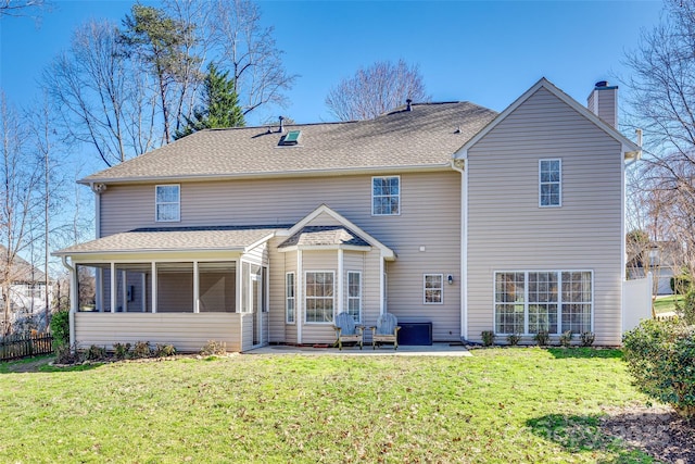 back of property featuring a patio area, a lawn, and a sunroom