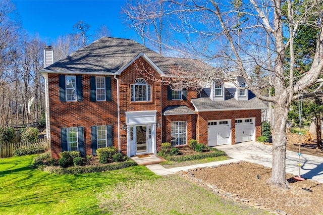 view of front of home featuring a front lawn and a garage