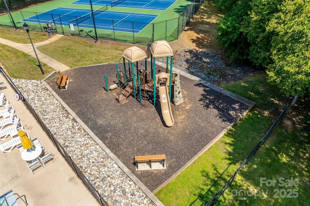 view of play area featuring a yard and tennis court