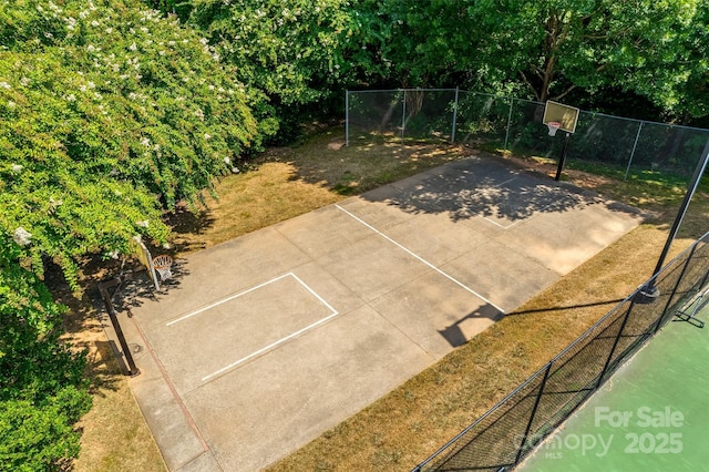 view of basketball court featuring a lawn