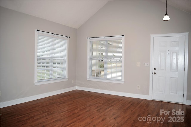 foyer featuring dark wood-style flooring, a healthy amount of sunlight, and vaulted ceiling