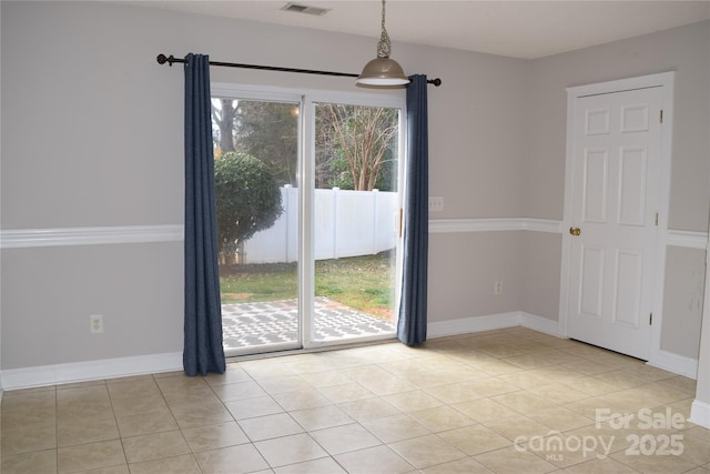 spare room with visible vents, plenty of natural light, baseboards, and light tile patterned floors