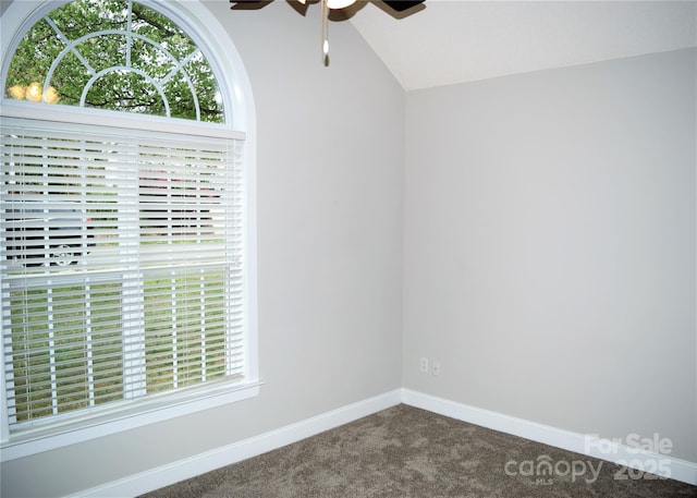 unfurnished room featuring ceiling fan, carpet, baseboards, and vaulted ceiling