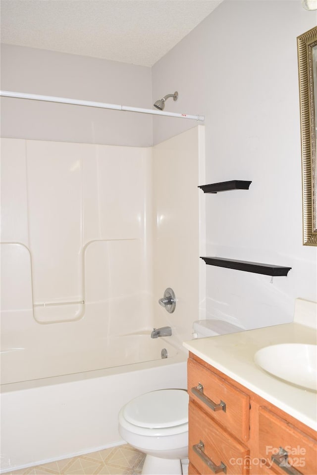 full bath featuring a textured ceiling, bathing tub / shower combination, toilet, and vanity