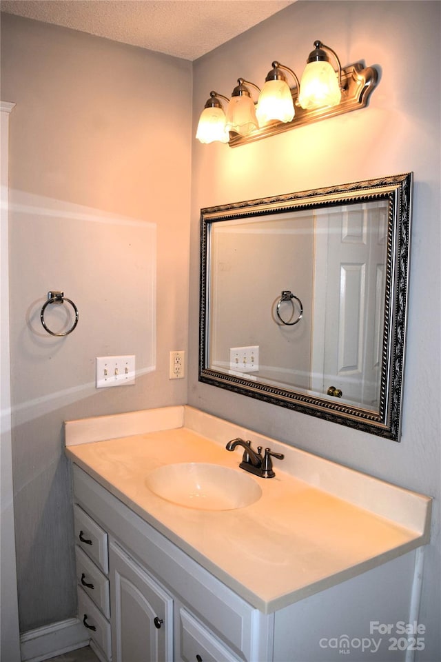 bathroom with a textured ceiling and vanity