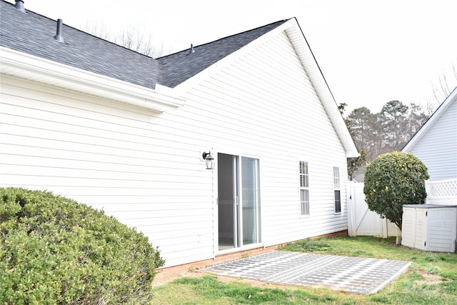 back of property featuring fence and roof with shingles