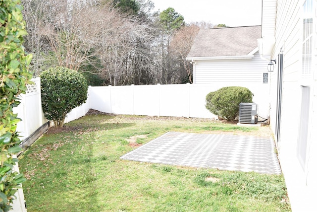 view of yard featuring central air condition unit, a patio area, and a fenced backyard