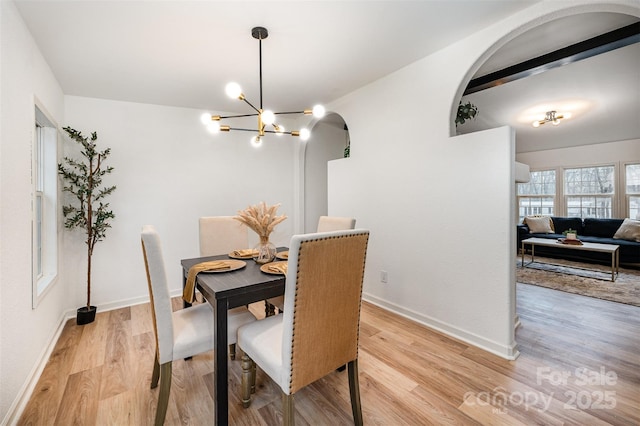 dining room with a chandelier and light hardwood / wood-style floors