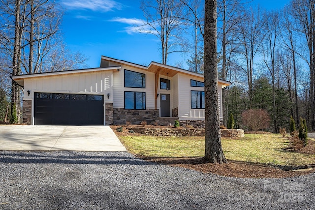 contemporary home featuring a garage and a front lawn