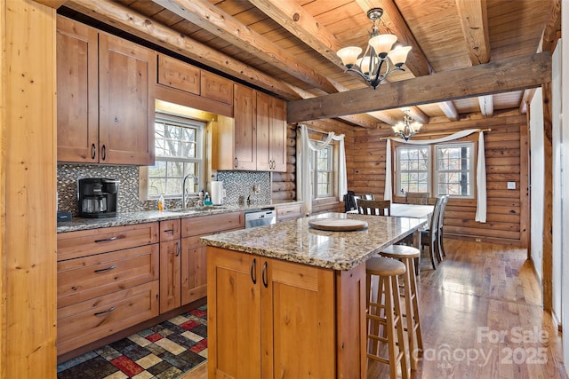 kitchen with a chandelier, wooden ceiling, a breakfast bar, a sink, and decorative backsplash