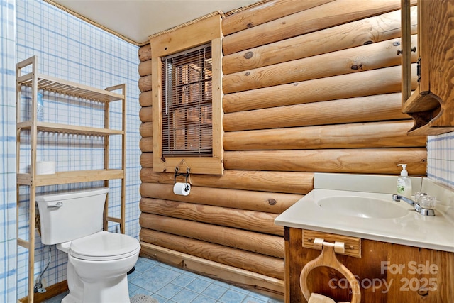 half bathroom with toilet, tile patterned flooring, vanity, and log walls