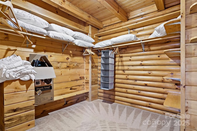 spacious closet with carpet floors and beamed ceiling