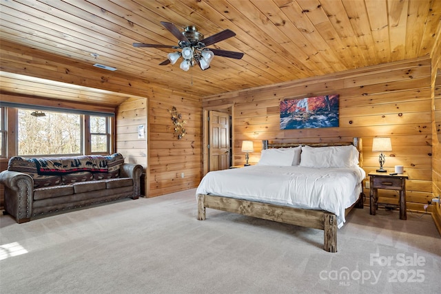 bedroom with wooden ceiling, carpet, wooden walls, and ceiling fan