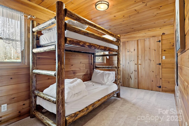 bedroom featuring carpet floors, wooden ceiling, and wood walls