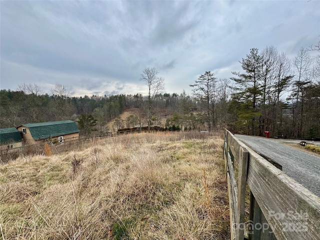 view of road featuring a wooded view