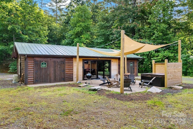 40/44 Chambers Dr, Weaverville, NC 28787 - back of property with a patio, a hot tub, and a metal roof