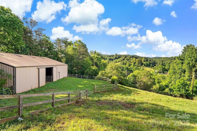 40/44 Chambers Dr, Weaverville, NC 28787 - view of yard featuring a forest view, an outbuilding, an exterior structure, and a pole building