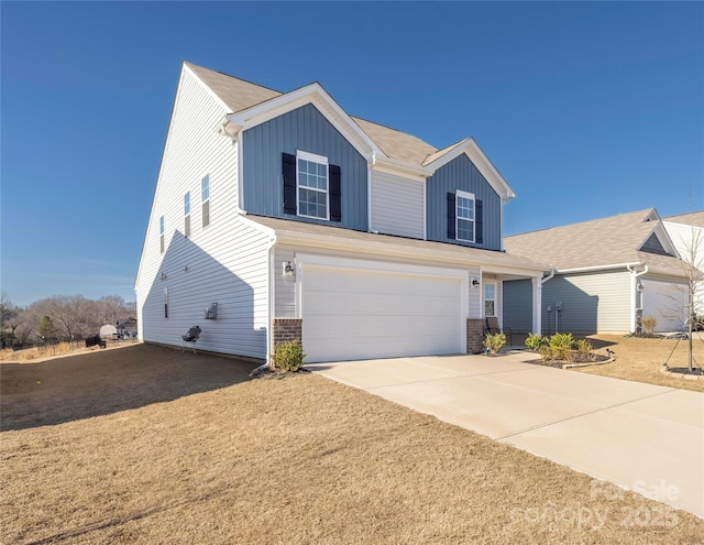 traditional home featuring driveway, brick siding, board and batten siding, and an attached garage