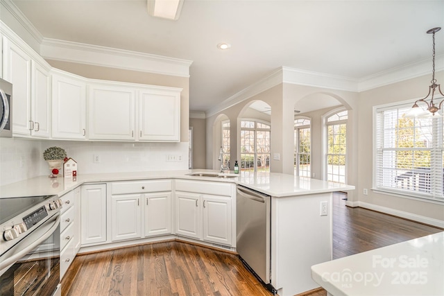 kitchen featuring light countertops, appliances with stainless steel finishes, and white cabinetry