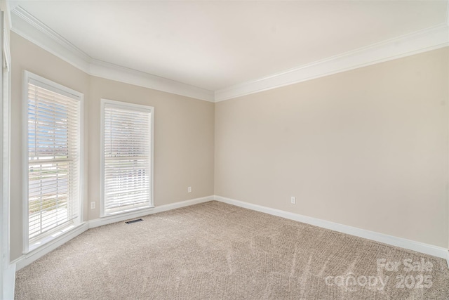 unfurnished room featuring carpet floors, baseboards, visible vents, and ornamental molding