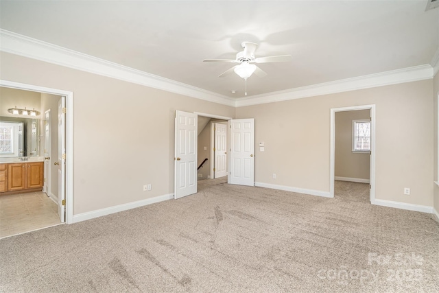 unfurnished bedroom featuring baseboards, crown molding, and light colored carpet