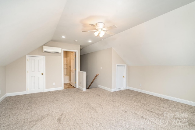 additional living space featuring lofted ceiling, recessed lighting, baseboards, a wall mounted AC, and carpet