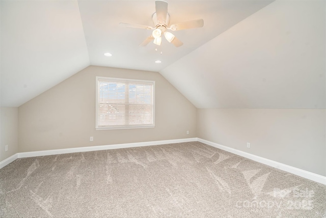 bonus room with lofted ceiling, ceiling fan, carpet, and baseboards