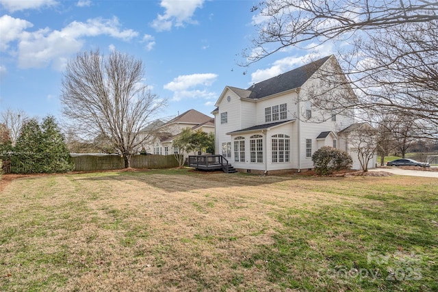 rear view of property with a yard, crawl space, fence, and a wooden deck