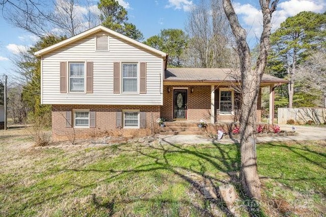 tri-level home with a front lawn and a porch