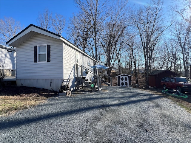 view of home's exterior with a storage unit and an outdoor structure