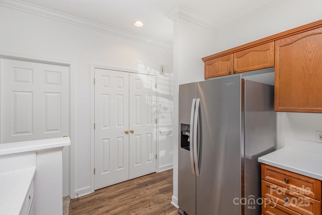 kitchen with ornamental molding, dark wood-type flooring, and stainless steel fridge with ice dispenser