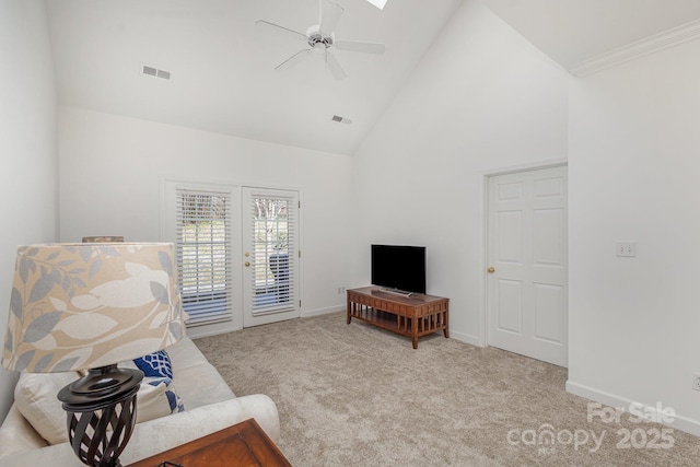 living room with ceiling fan, high vaulted ceiling, french doors, and light carpet