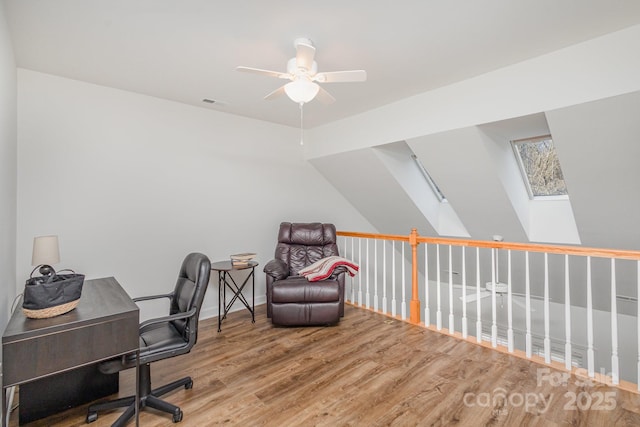 office area featuring hardwood / wood-style floors, ceiling fan, and a skylight