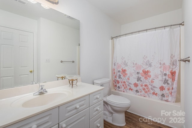 full bathroom featuring toilet, wood-type flooring, vanity, and shower / bath combination with curtain