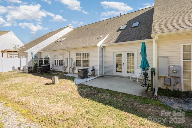 back of house featuring central air condition unit, a patio area, french doors, and a yard