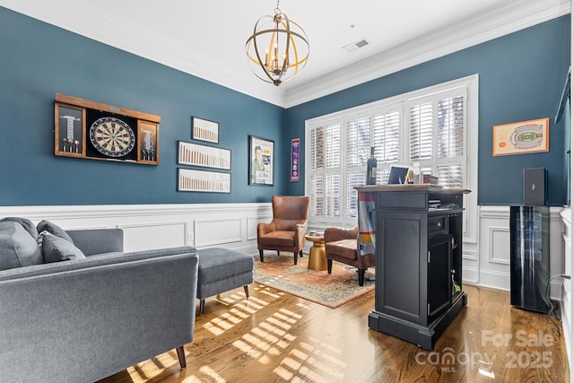 interior space featuring a chandelier, crown molding, and wood-type flooring