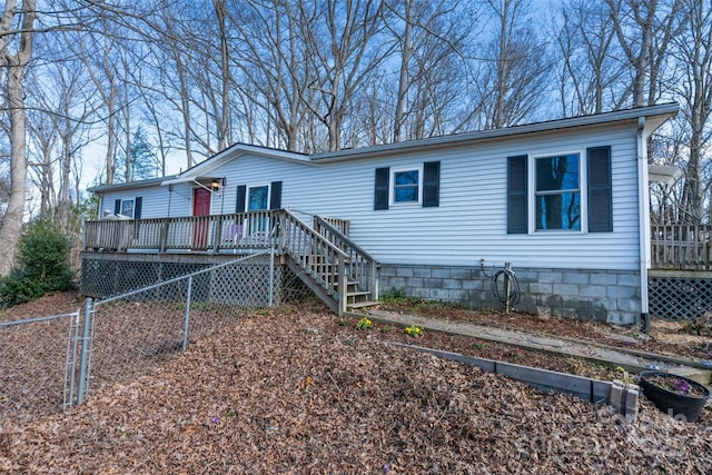 view of front of home featuring fence, stairway, and a deck