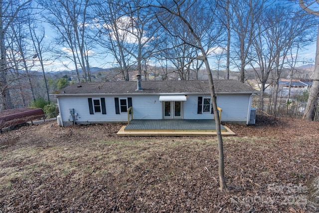 rear view of house with a wooden deck