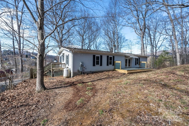 view of front facade with fence and a wooden deck