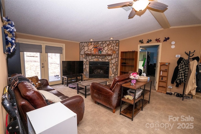 carpeted living area with french doors, a fireplace, ornamental molding, vaulted ceiling, and a textured ceiling