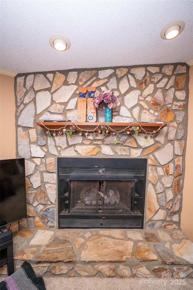 room details with ornamental molding, a fireplace, and a textured ceiling