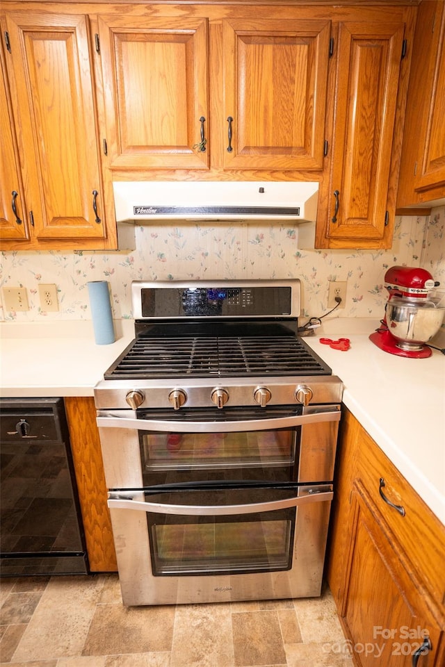 kitchen with range with two ovens, black dishwasher, light countertops, and exhaust hood